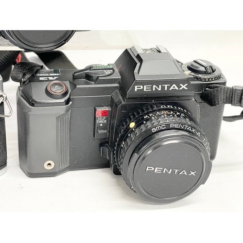 424 - 3 Pentax cameras. A Pentax P30 camera. A Pentax Asahi Spotmatic camera. A Pentax A3 camera.