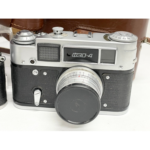 427 - 4 vintage cameras in cases. A Minolta Uniomat camera. A Ricoh 35 camera.  A FED 4 camera. An Exa Iha... 