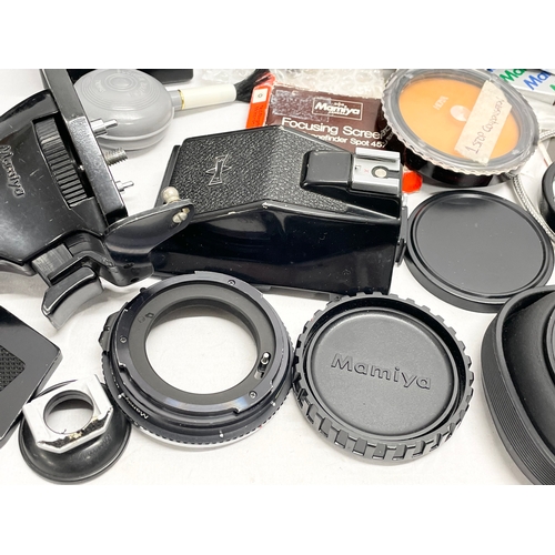 429 - A quantity of Mamiya camera equipment, including parts of the M645 Super camera. etc. A Mamiya pisto... 