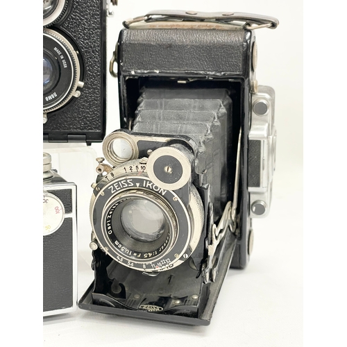 432 - A collection of vintage cameras. A Zeiss Ikon Compur Rapid folding camera. A Lubitel 166 Universal c... 