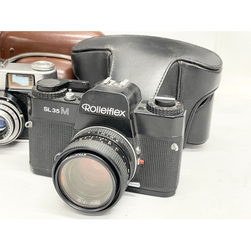 437 - A collection of vintage cameras. A Rolleiflex SL35 M camera in case. A Voigtlander Vitoret camera in... 