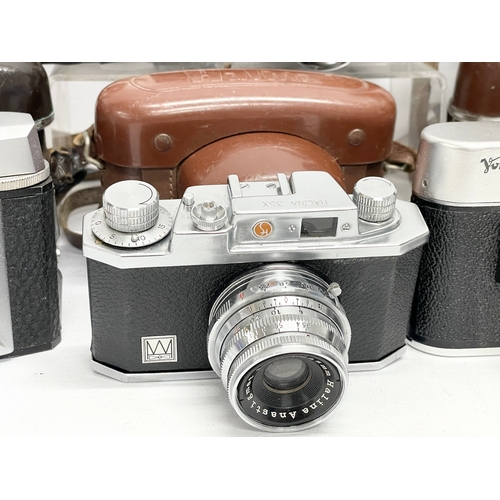 437 - A collection of vintage cameras. A Rolleiflex SL35 M camera in case. A Voigtlander Vitoret camera in... 