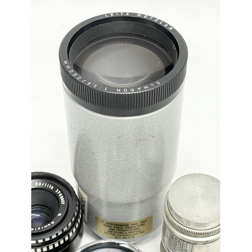 440 - 4 German camera lenses. A Leitz Wetzlar Elmaron 1:36/200mm lens. A Staeble Telexon 1:56/85 528767 E ... 