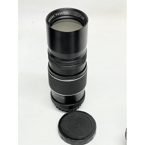 447 - A collection of camera lenses. A Sigma UC Zoom 70-210mm Multi Coated lens. A Kowa AUX Telephoto lens... 