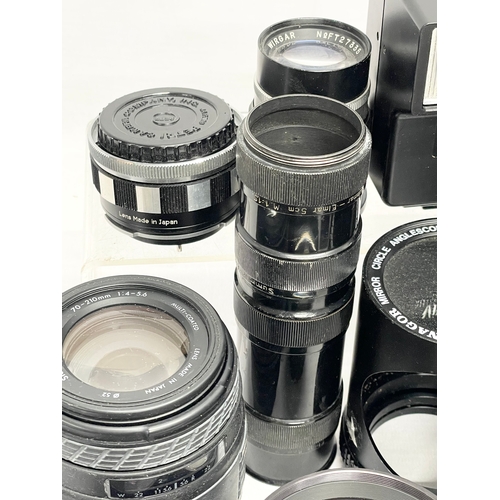 447 - A collection of camera lenses. A Sigma UC Zoom 70-210mm Multi Coated lens. A Kowa AUX Telephoto lens... 