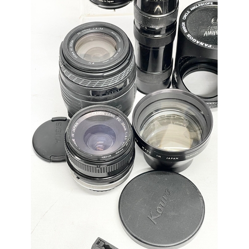 447 - A collection of camera lenses. A Sigma UC Zoom 70-210mm Multi Coated lens. A Kowa AUX Telephoto lens... 