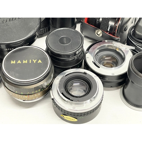 447 - A collection of camera lenses. A Sigma UC Zoom 70-210mm Multi Coated lens. A Kowa AUX Telephoto lens... 