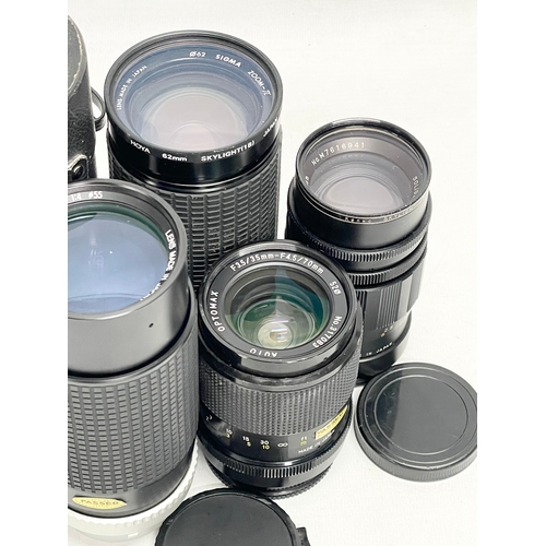 448 - A quantity of camera lenses. A Hoya HMC Zoom 80-200mm 1:4 lens in case. A Sigma Zoom-JL Multi Coated... 