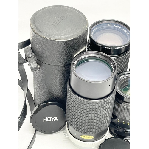 448 - A quantity of camera lenses. A Hoya HMC Zoom 80-200mm 1:4 lens in case. A Sigma Zoom-JL Multi Coated... 