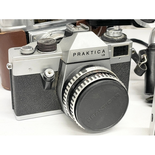 454 - A collection of vintage cameras. A Miranda MS-3 camera. Halina 6-4 camera in case. A Praktica LB cam... 