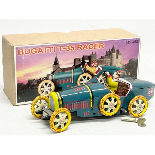 531 - 2 tin plate wine up toys in boxes. A Moon Explorer in box and a Bugatti T-35 Racer in box.