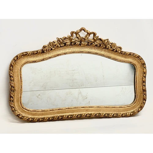 136 - A vintage ornate gilt wooden framed mirror. 88x56cm