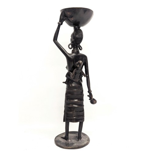 616 - An early 20th century African bronze figure. 35cm