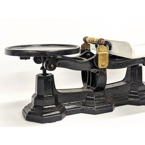 137 - A large set of late Victorian cast iron grocer scales.