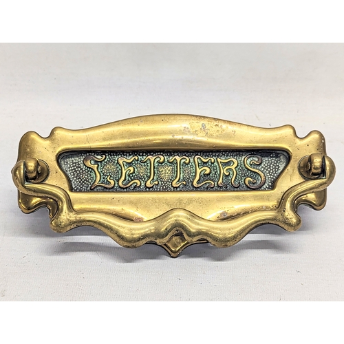 323 - A late Victorian Art Nouveau brass door knocker, circa 1890s. 21x11cm