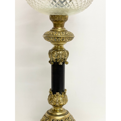 146 - A large good quality Victorian ornate brass oil lamp, with an etched Cranberry Glass shade. 80cm