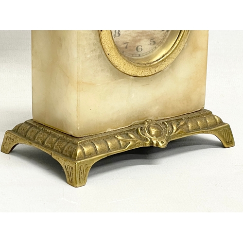 46 - An early 20th century ornate brass and onyx wind up mantle clock. 11x6x18cm