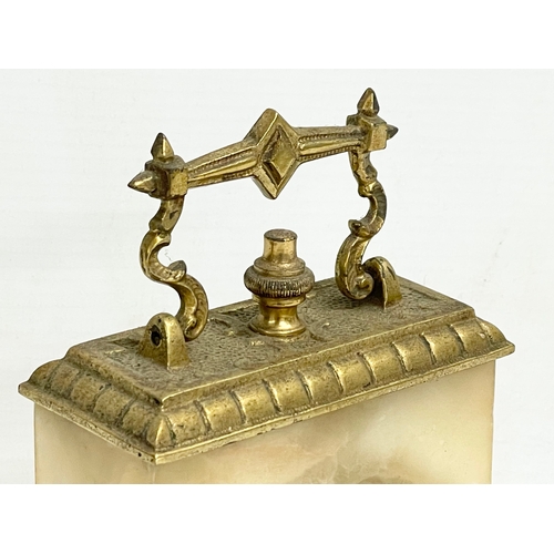 46 - An early 20th century ornate brass and onyx wind up mantle clock. 11x6x18cm