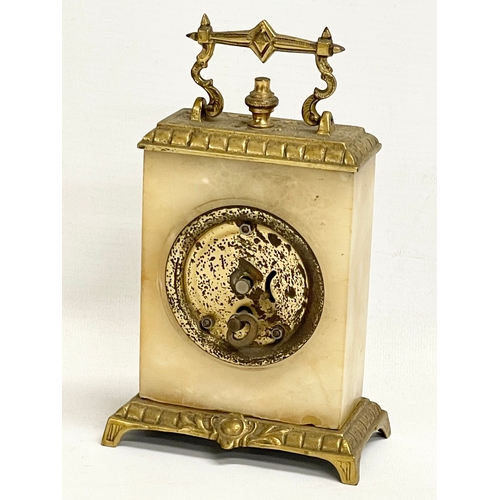 46 - An early 20th century ornate brass and onyx wind up mantle clock. 11x6x18cm