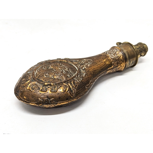 128 - A 19th century ornate copper and brass gun powder flask. 21cm