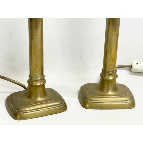 153 - A pair of tall early 20th century brass lamps. 39cm