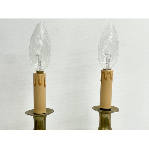 153 - A pair of tall early 20th century brass lamps. 39cm