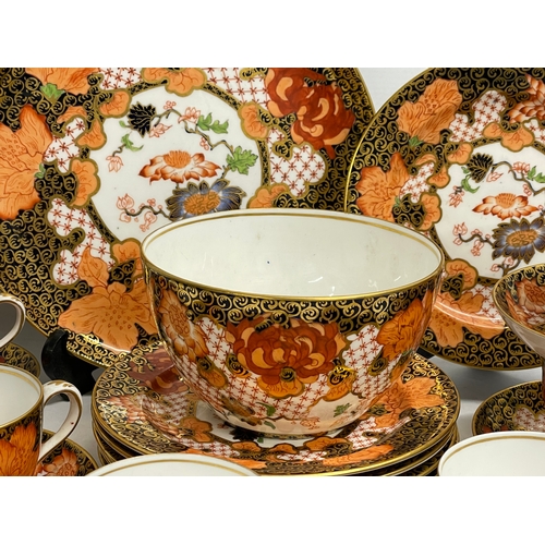 634 - A 20 piece Royal Crown Derby Imari pattern porcelain tea set. Largest plate measures 23.5cm. Sugar b... 