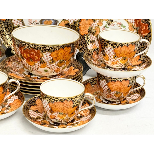 634 - A 20 piece Royal Crown Derby Imari pattern porcelain tea set. Largest plate measures 23.5cm. Sugar b... 