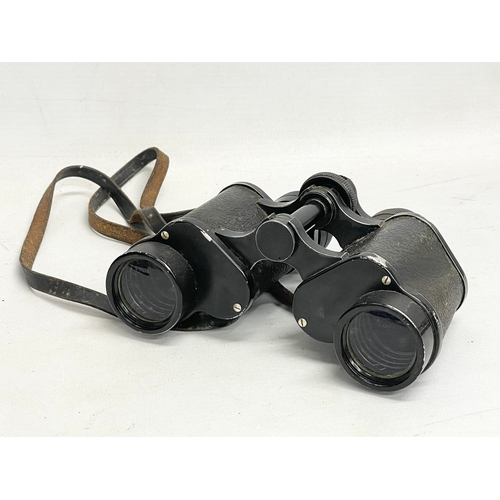 563 - A pair of binoculars in leather case.