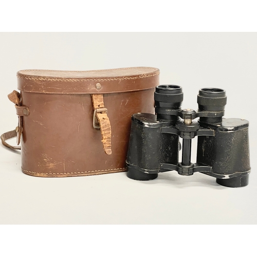 563 - A pair of binoculars in leather case.