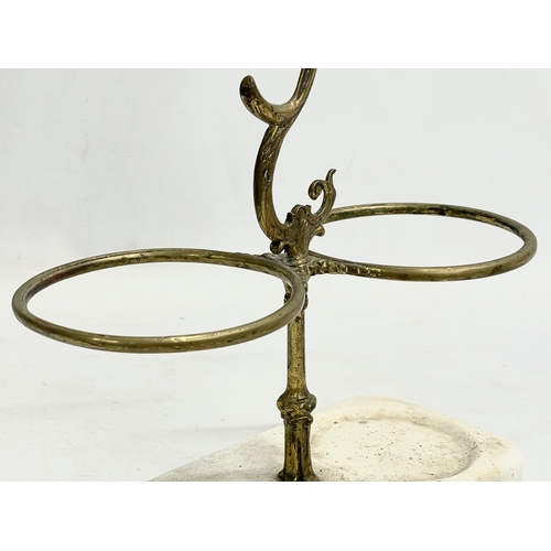 63 - A Victorian ornate brass wine bottle holder on stoneware base. 25.5x29cm.