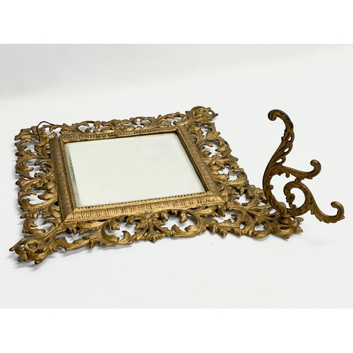 91 - A Victorian ornate brass framed bevelled mirror with hat hook. 47x53cm.