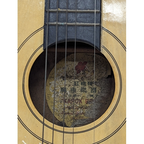 593 - A vintage acoustic guitar.