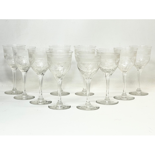 669 - A set of 10 early 20th century etched wine glasses. 15cm