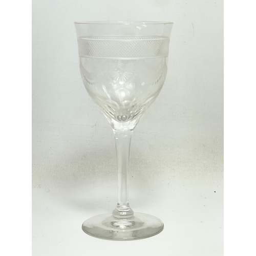 669 - A set of 10 early 20th century etched wine glasses. 15cm