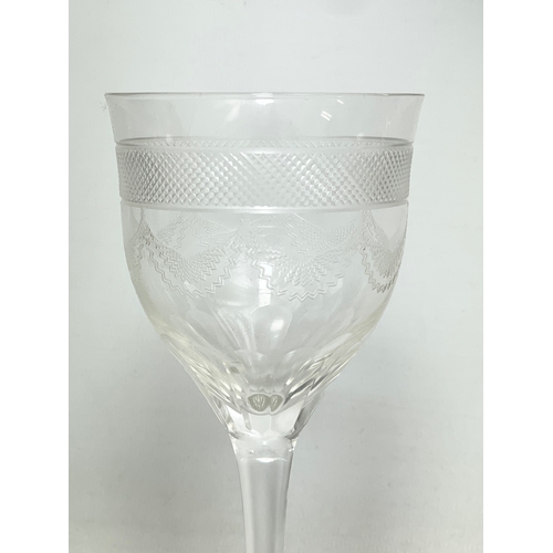 669 - A set of 10 early 20th century etched wine glasses. 15cm