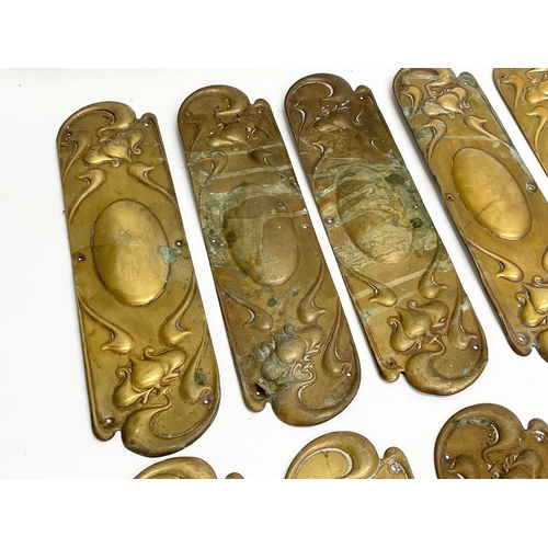 94 - A set of 13 late 19th century Art Nouveau brass finger plates. 7.5x29cm