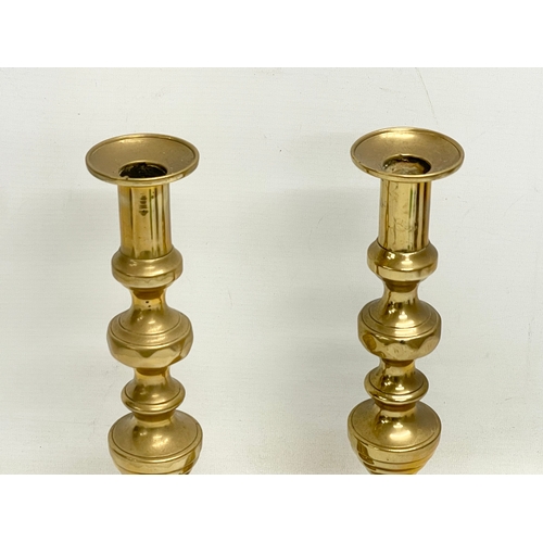 677 - A pair of large Victorian brass candlesticks. 30.5cm