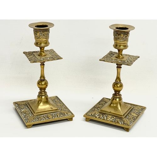 678 - A pair of early 20th century ornate brass candlesticks 16cm.