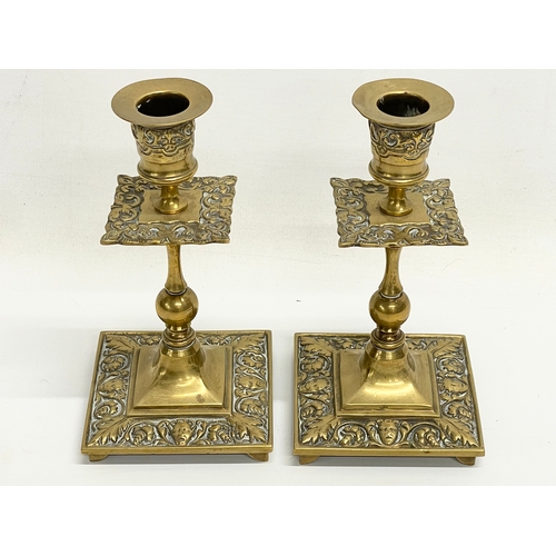 678 - A pair of early 20th century ornate brass candlesticks 16cm.