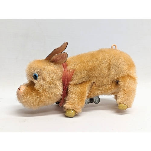 576 - A vintage wind up 'Sniffing Rooting Pig.' Made in Japan by TN (Toys Nomura). Box measures 16x10cm