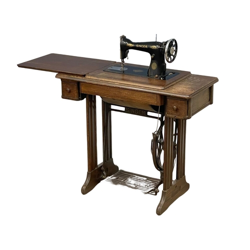 365 - A vintage oak Singer Sewing machine with accessories etc. 87x42x78cm