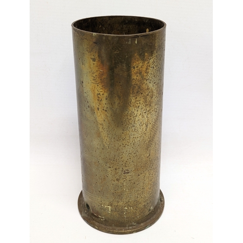 402 - A brass World War II canon shell, stamped 1940.