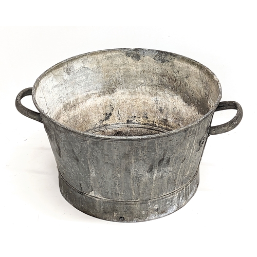 491 - A vintage galvanized two handled basin with lid. 49x34cm