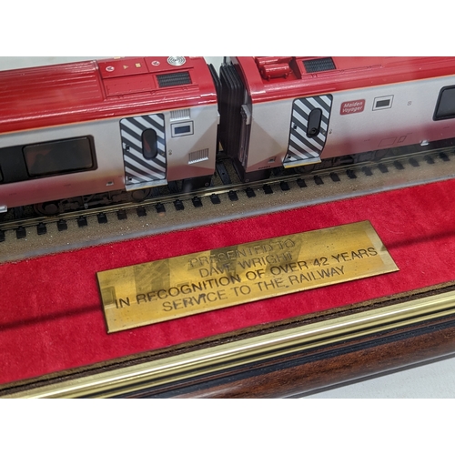 585H - A large model train in case, presented to Dave Wright in recognition of 42 years service to the rail... 