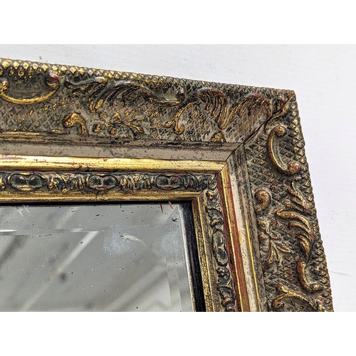 399 - A large ornate gilt framed bevelled mirror. 85x60.5cm