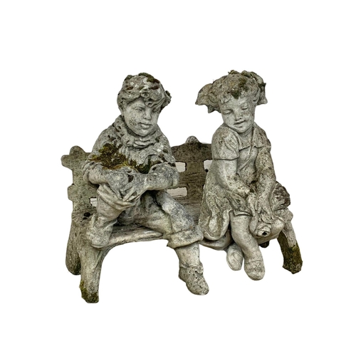 502 - A vintage 3 piece concrete garden ornament of children on bench. 74x62cm.