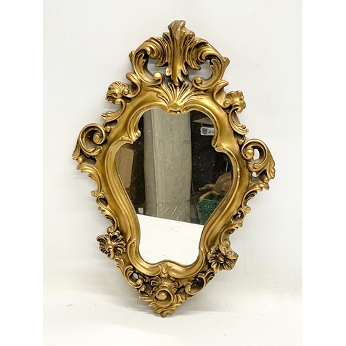 393 - A vintage 18th century style ornate gilt framed mirror. 33x49cm