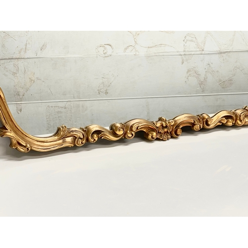 395 - A large Rococo 18th century style ornate gilt framed mirror. 122x87cm