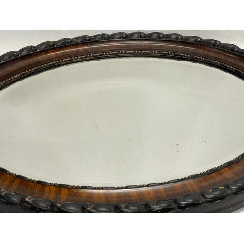 519 - An Edwardian mahogany oval framed mirror. 60x65cm